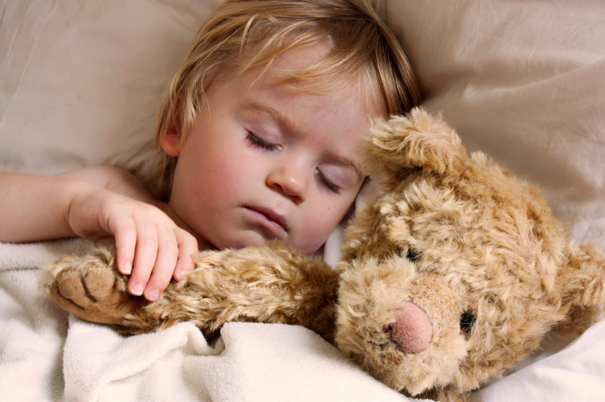 Toddler sleeping with teddy bear