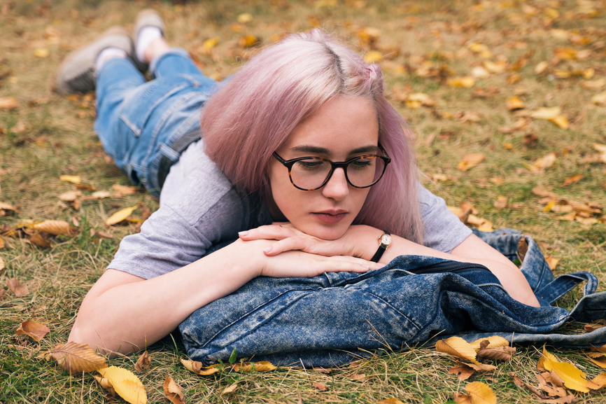 Teen laying in the grass