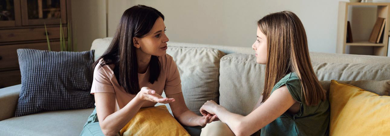 Mother conversing with daughter