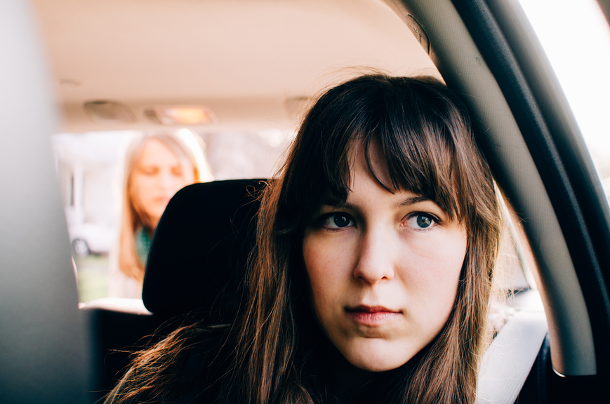 Teen sitting in car