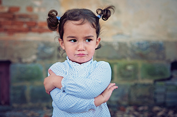 Young girl with arms crossed