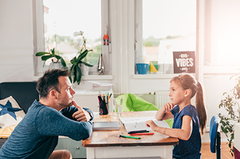 Dad and daughter studying