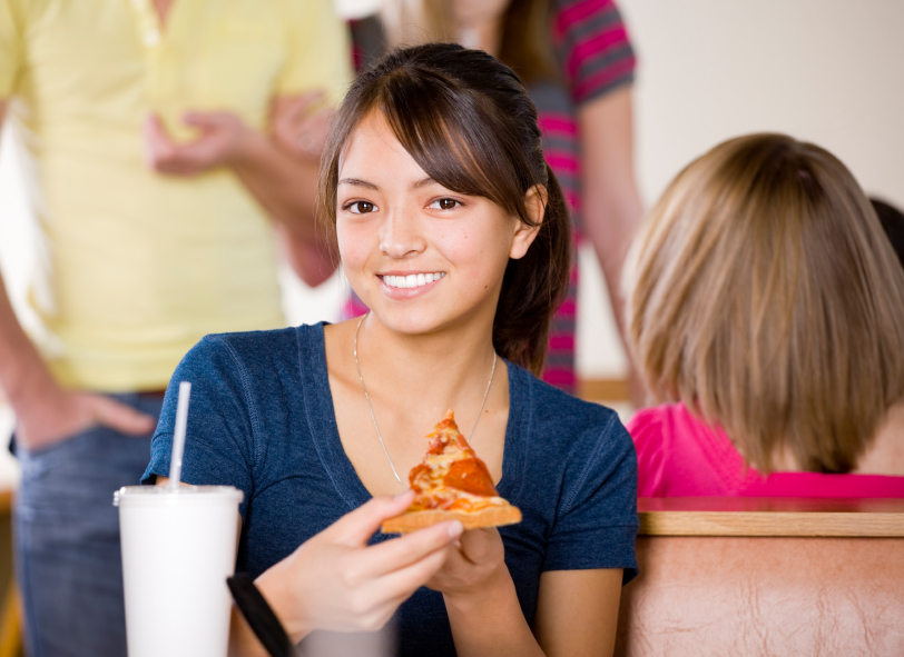 Teen eating pizza