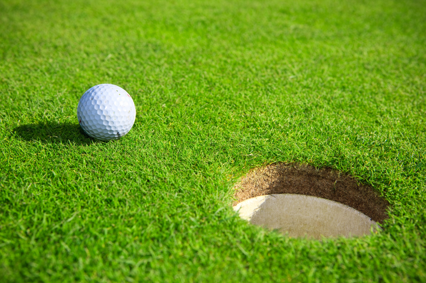 Golf ball close to hole