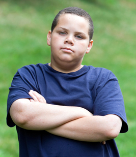 Upset boy with arms crossed