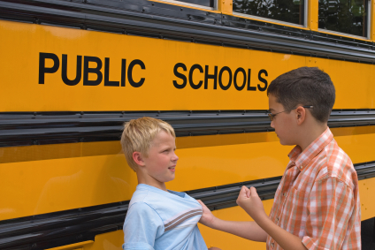Child raising fist to another child
