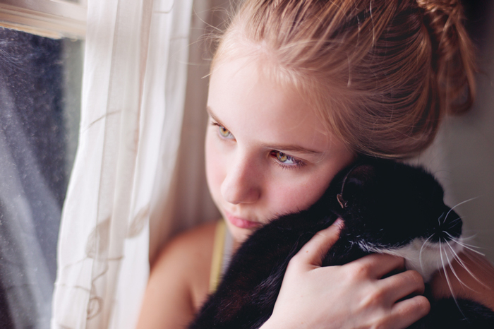 anxious child with kitten