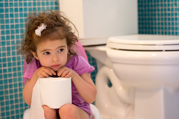 Girl looking stressed holding toilet paper