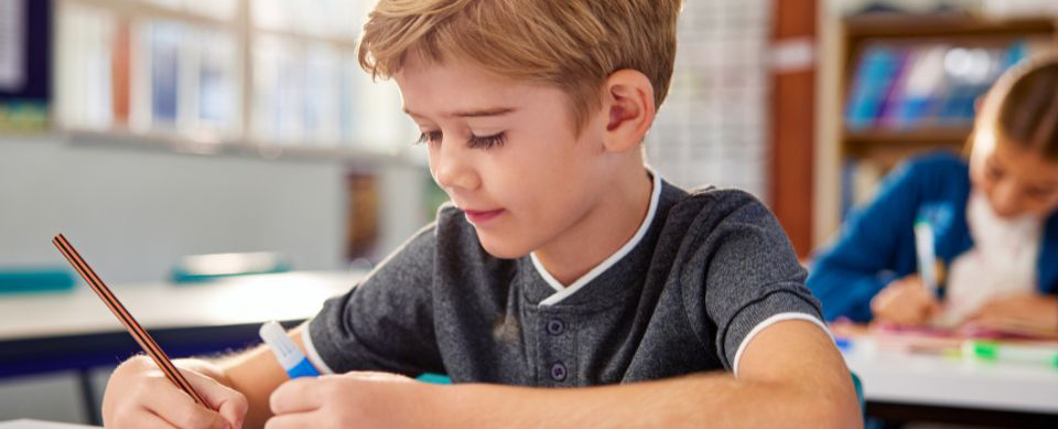 Young kid writing on paper