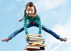 girl jumping over books