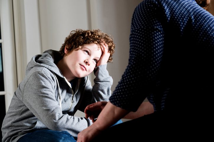 upset boy talking to parent