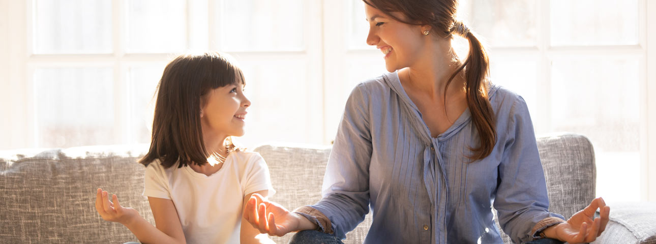 Mom and daughter meditating happily  